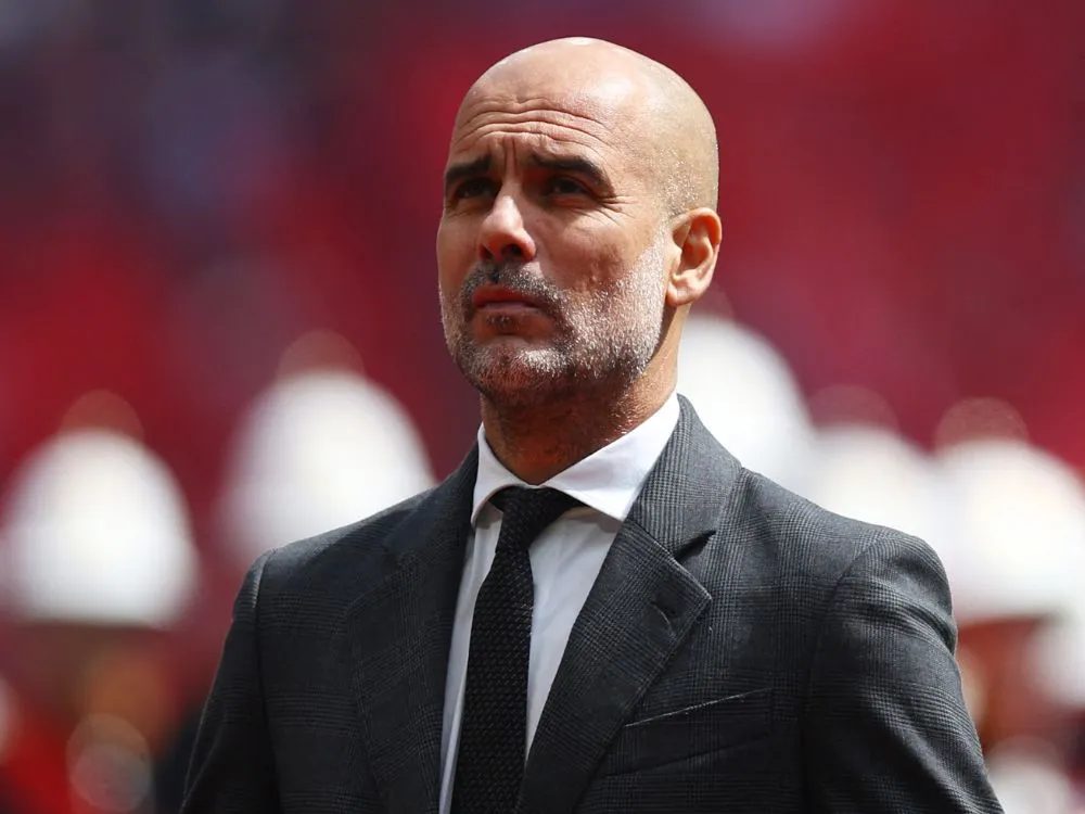 Pep Guardiola expressing concerns over Manchester City's squad size during a press conference in 2025.